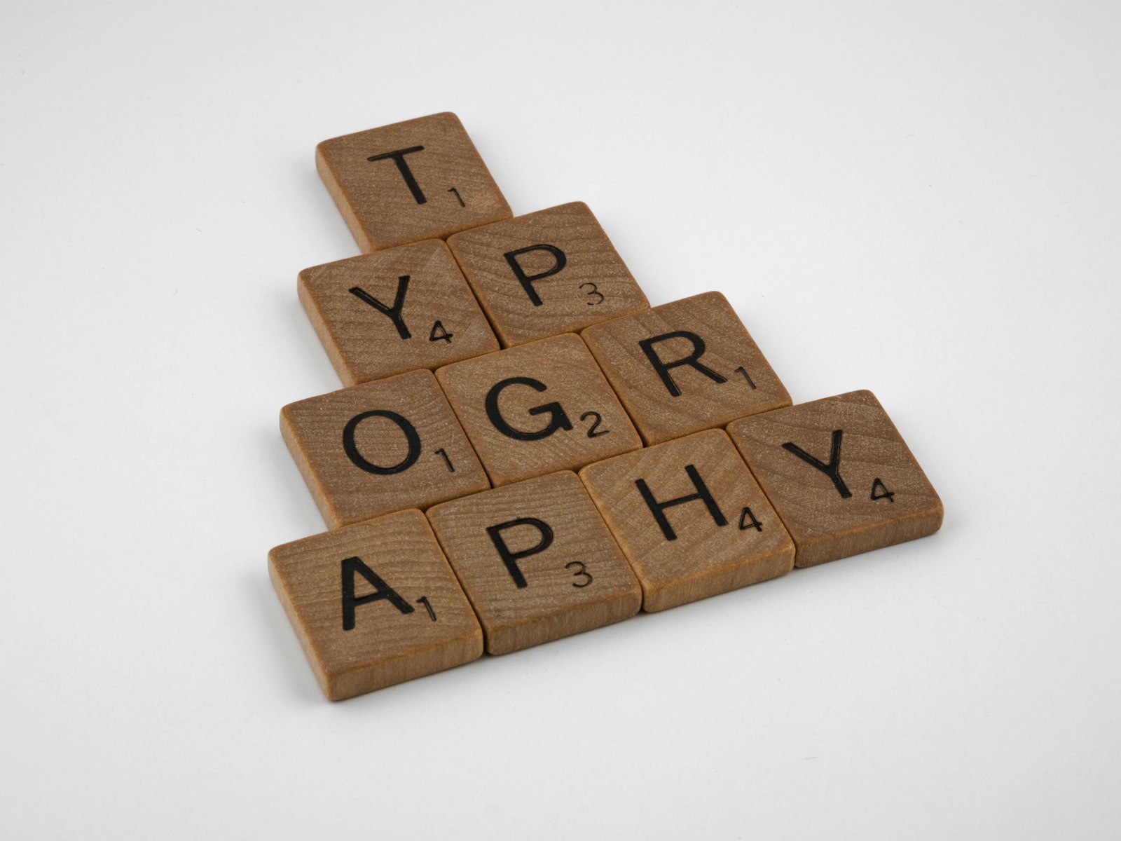 brown wooden puzzle blocks on white surface