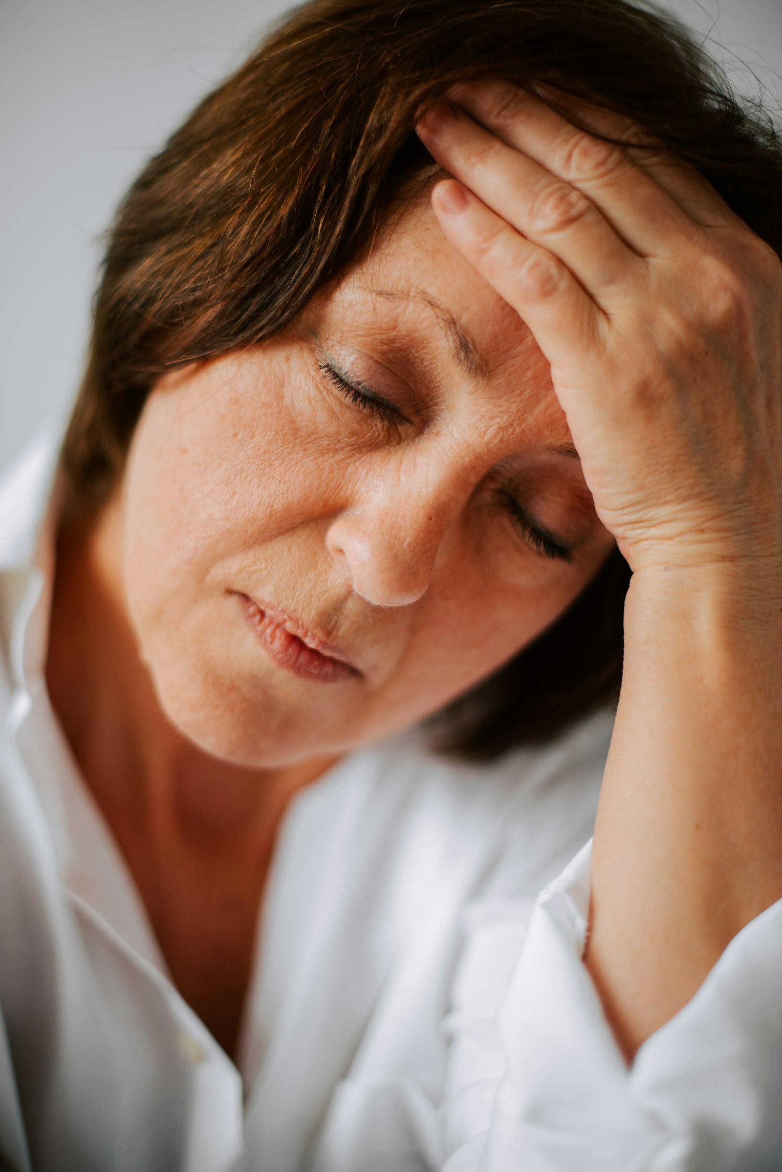 a woman holding her head in her hands